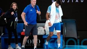 Novak Djokovic limps into round three in Melbourne as injury worries remain